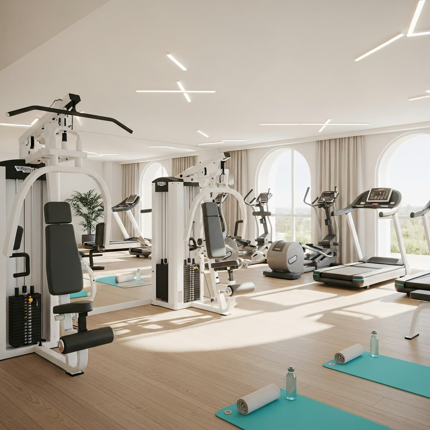 Bright gym floor with treadmills, weight machines and tall windows